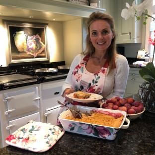 Geri Halliwell in a kitchen, holding a plate of plum crumble.