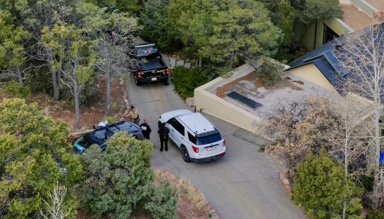 Aerial view of Santa Fe County deputies outside a house.