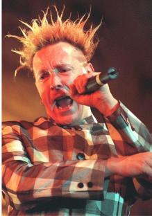 Johnny Rotten, lead singer of the Sex Pistols, performing on stage.