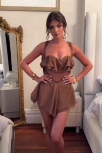 Samie Elishi in a brown cutout dress.