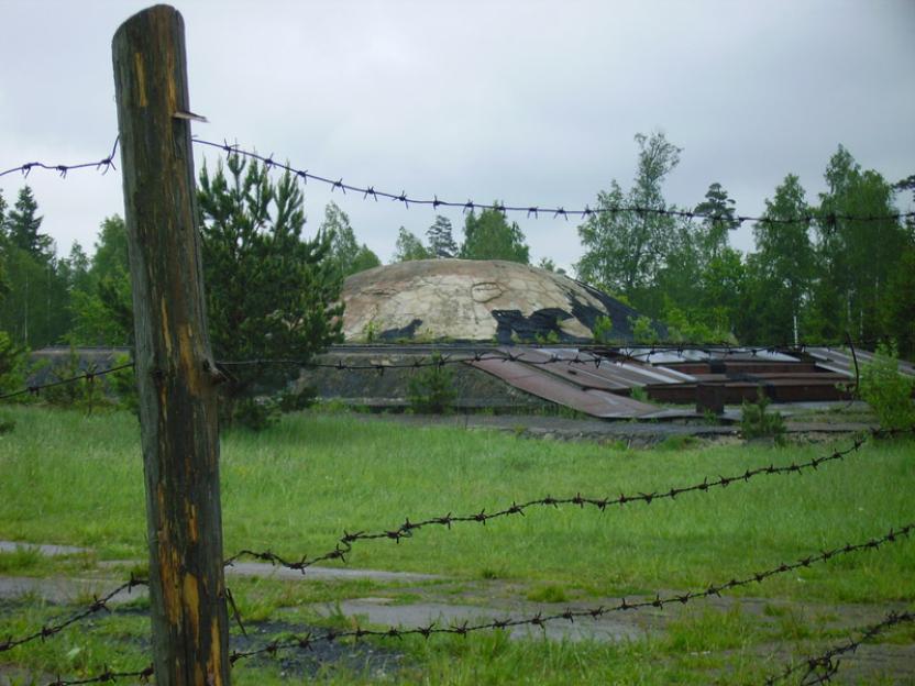 Barbed wire fence in front of an abandoned Soviet-era nuclear missile base.