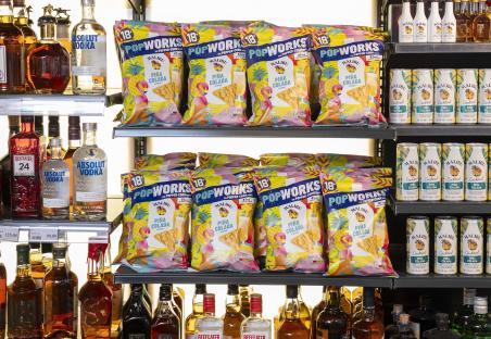 Store shelves stocked with Malibu Pina Colada-flavored PopWorks popped corn and Malibu Pina Colada cocktails.