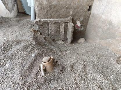 Pompeii excavation site showing a 2000-year-old bed used as a barricade.