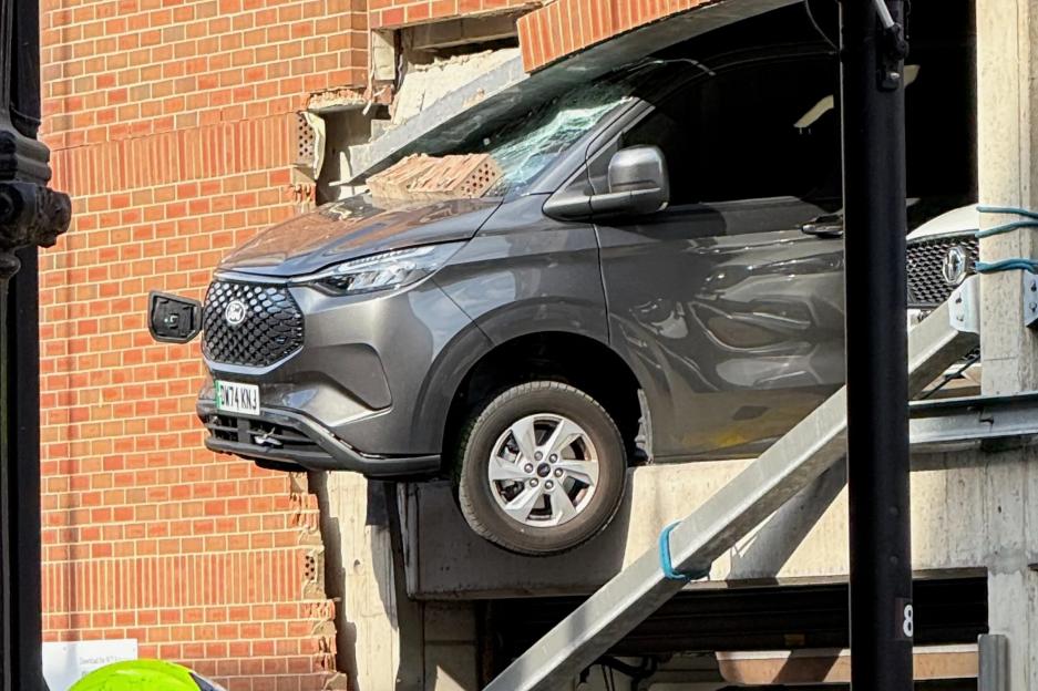Three pedestrians injured by falling rubble as van crashes through multi-storey car park wall in UK city centre