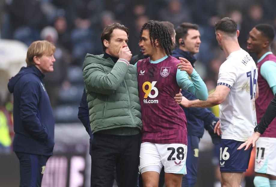 Scott Parker, Burnley's manager, speaks with a player.