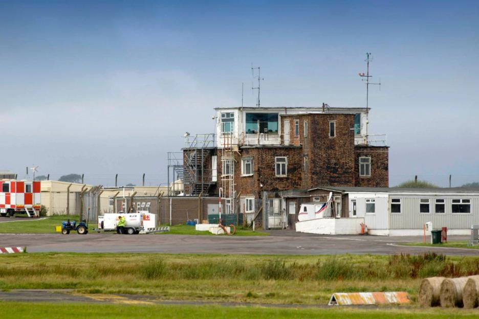 Plane crashes and overturns on runway at UK airport after ‘pilot error’ as two rushed to hospital