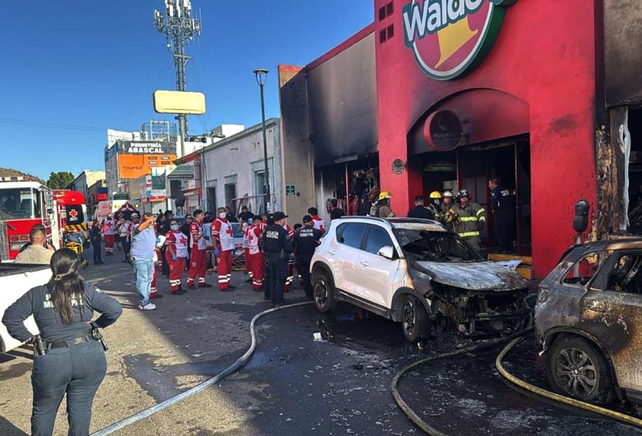 Rescuers work at a fire-damaged chain department store in Hermosillo, Sonora state, northern Mexico, on Nov. 1, 2025.