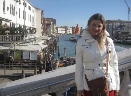 Woman in white coat in Venice, Italy.