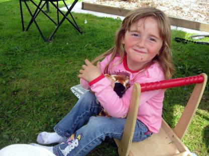 Young girl holding stuffed animal.