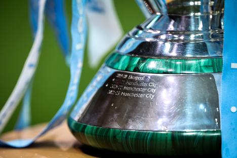 Close-up of the Premier League trophy base, showing engravings of Manchester City's wins.