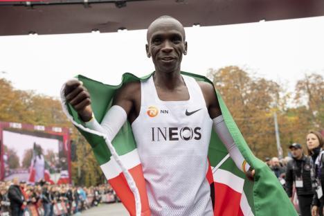epa07914790 Eliud Kipchoge, Kenyan marathon world record holder, celebrates with the flag of Kenya in front of the finish line after the INEOS 1:59 Challenge in Vienna, Austria, 12 October 2019. Kipchoge attempted on the day to beat his own record becoming the first person to run a marathon distance under two hours, recording a time of 1 hour 59 minutes 40 seconds at the event. EPA/CHRISTIAN BRUNA EDITORIAL USE ONLY