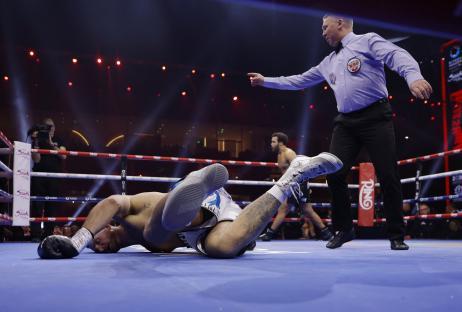 Moses Itauma knocks down Demsey McKean in a boxing match.
