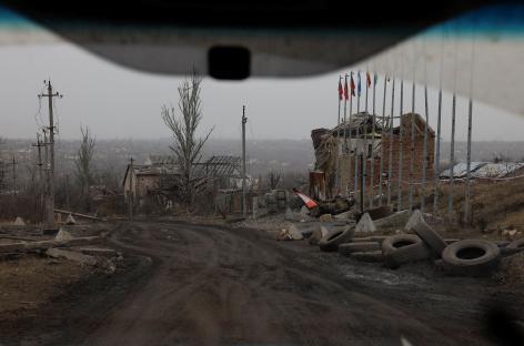 View from a car of destroyed buildings and a damaged tank in Avdiivka, Ukraine.