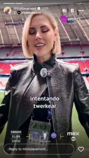 Woman in black leather jacket at a stadium.