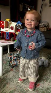 Toddler girl playing with toys.