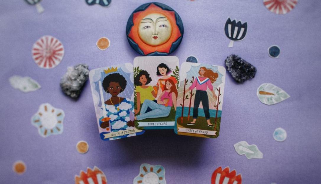 Three tarot cards: Queen of Swords, Three of Cups, and Three of Wands.