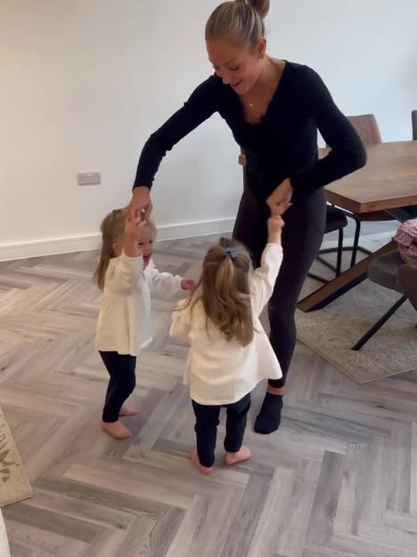 Amy Dowden dancing with two children.