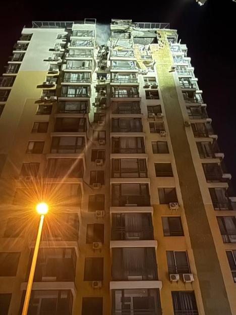 Bombed Kyiv apartment building at night.