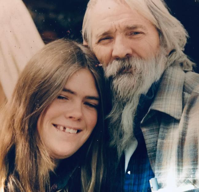 Photo of a young woman and an older man with a long white beard.