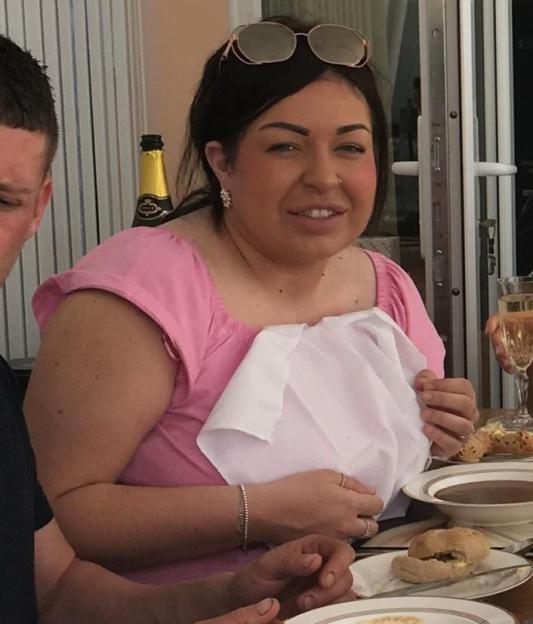 Two people eating soup at a table.