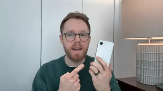 Man holding up a smartphone and gesturing.