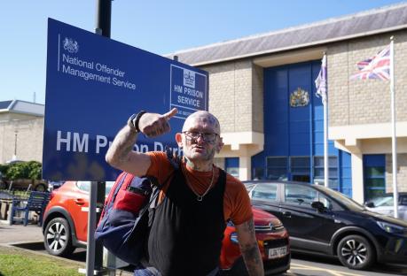 A tattooed man gives a thumbs-up outside HM Prison Durham.