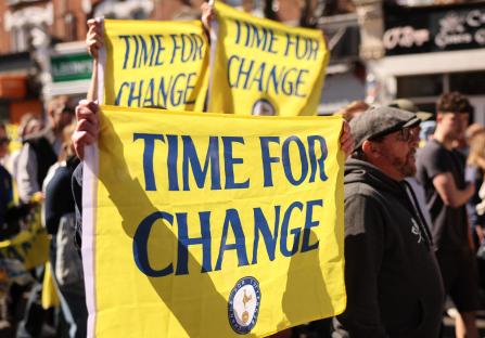 Tottenham Hotspur fans protesting with signs that read "Time for Change."