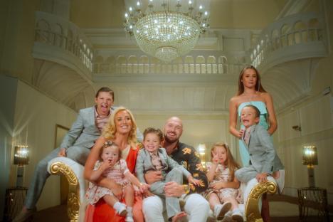 The Fury family posing for a photo on a chaise lounge.
