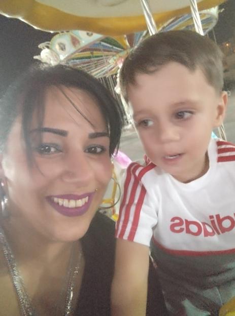 Correne Dadd, a woman with dark hair and purple lipstick, and her youngest son Zayaan.
