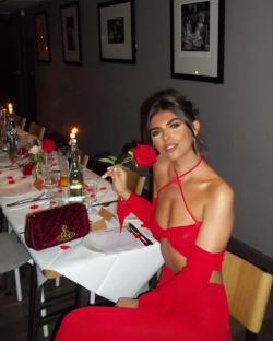 Samie Elishi in a red cutout dress at a romantic dinner.