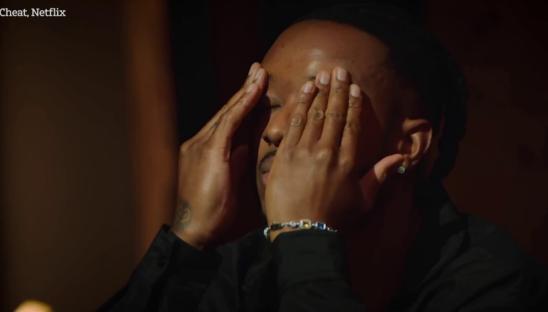 Man covering his face with his hands, appearing upset.