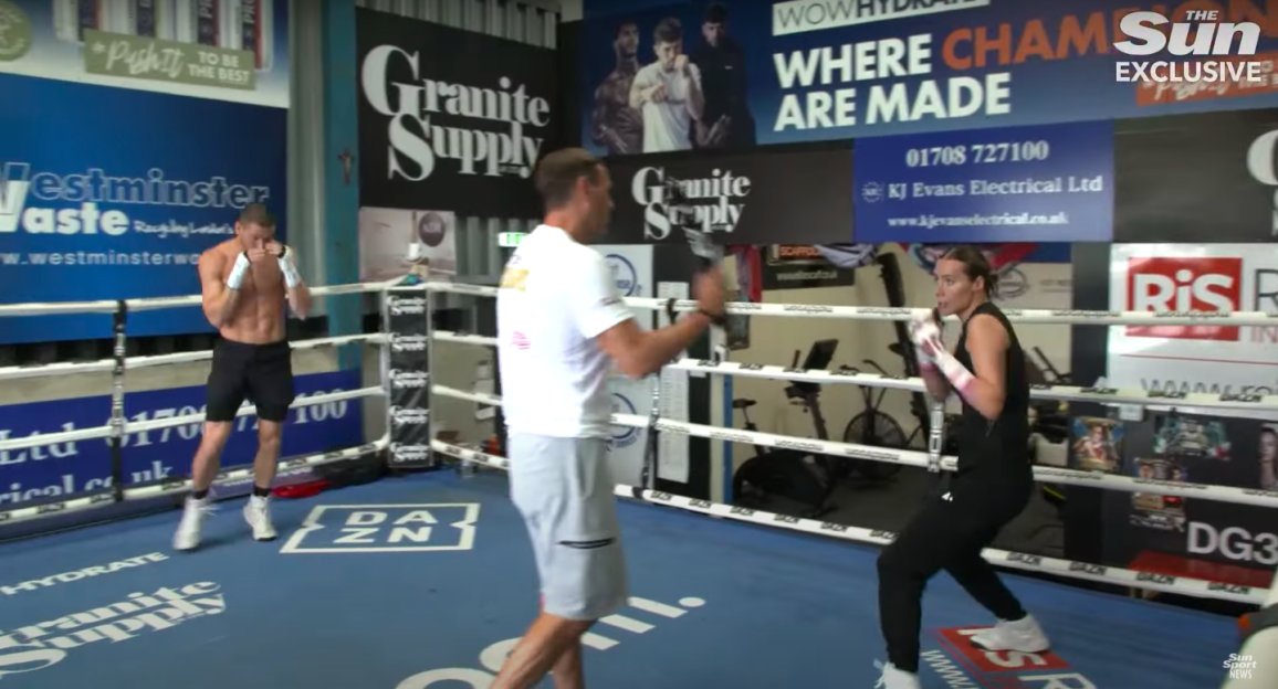 Boxers training in a boxing ring.