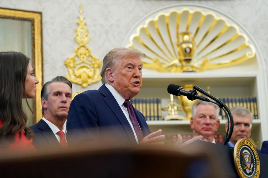 President Trump speaking at a podium in the Oval Office.