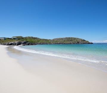 Scottish beach with white sand and turquoise water.