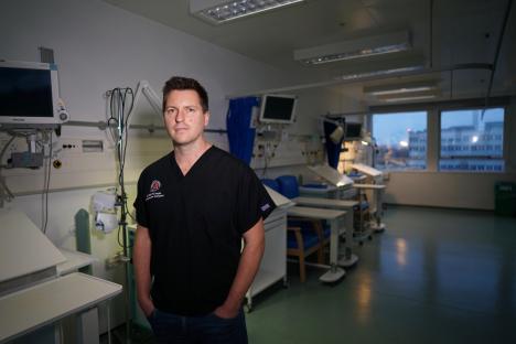 Portrait of a male doctor in a hospital ward.