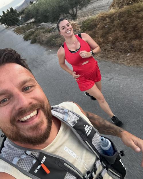 Smiling couple jogging outdoors.