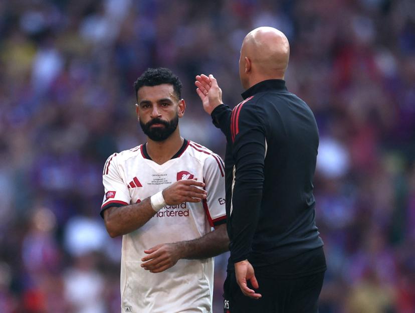 Mohamed Salah and Liverpool manager Arne Slot after a soccer match.