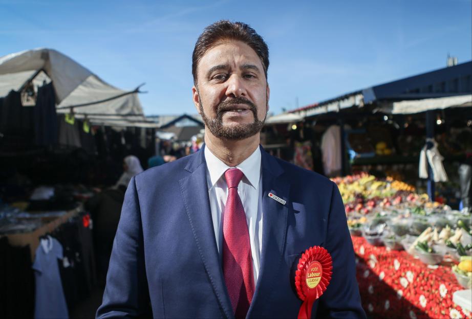 Afzal Khan, Labour's candidate, at a market.