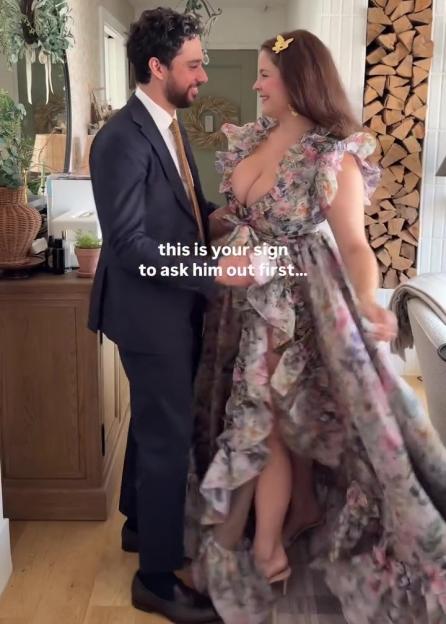 Woman in floral dress and man in suit. Text overlay: "this is your sign to ask him out first..."