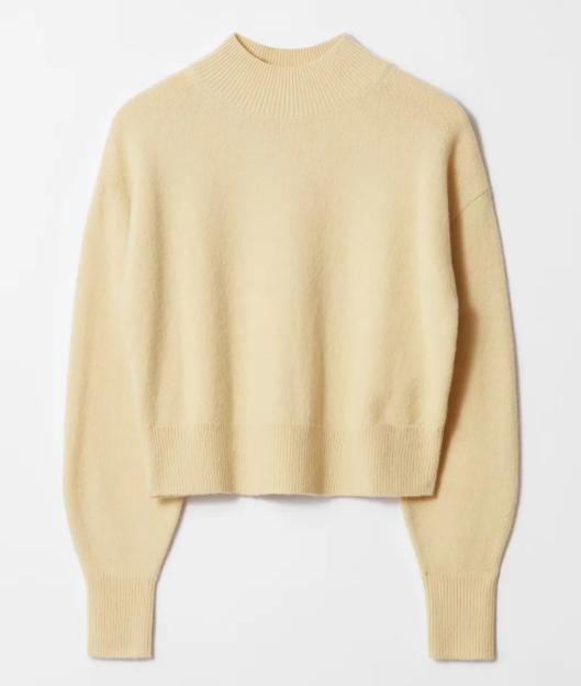 Pale yellow mock neck sweater.
