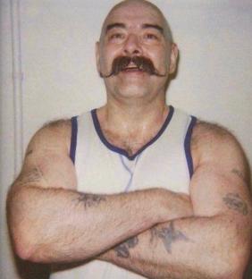 Charlie Bronson with arms crossed.