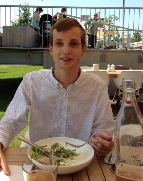 Photo of Gabriel Kovari eating at an outdoor restaurant.