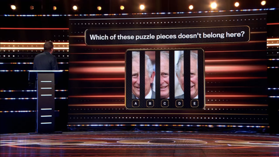 Screenshot of a game show screen displaying a puzzle: Which of five images of King Charles III doesn't belong?