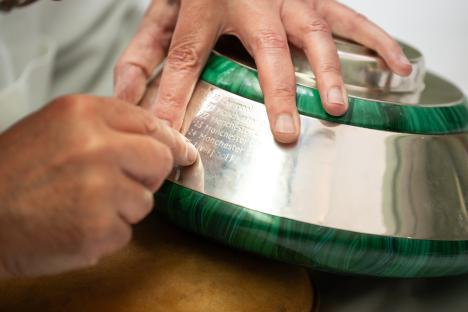 Engraving the Premier League trophy with winning teams' names.
