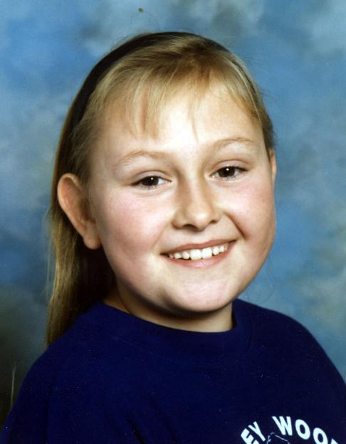 A young girl, Lucy Lowe, smiling.