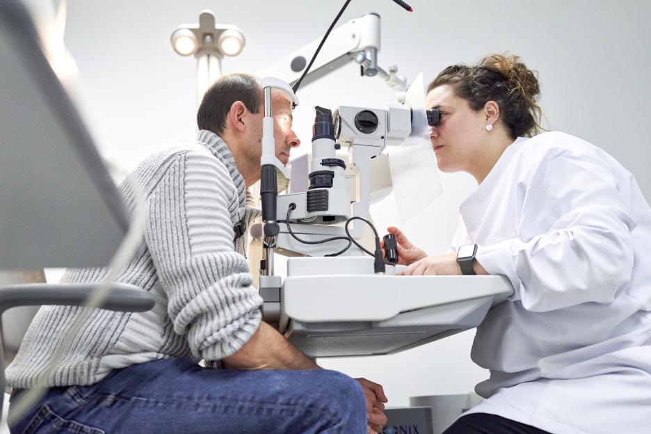 Ophthalmologist performing eye exam on a patient.