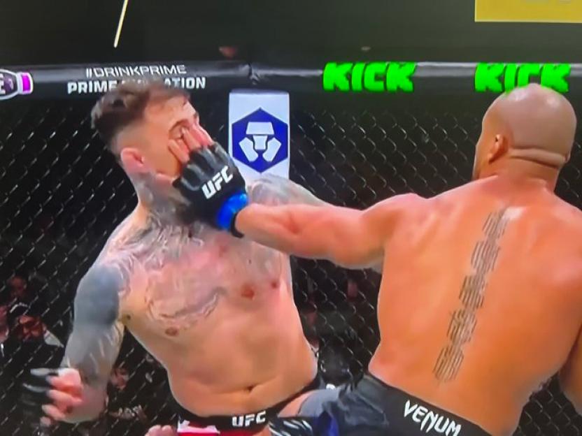 Tom Aspinall getting eye-poked in an MMA fight.