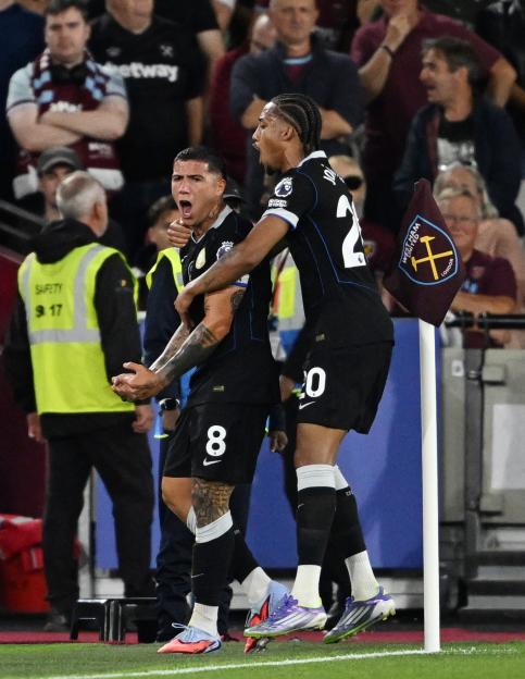 Enzo Fernandez of Chelsea celebrates a goal with a teammate.