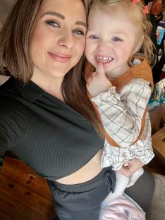 A woman holding a toddler.