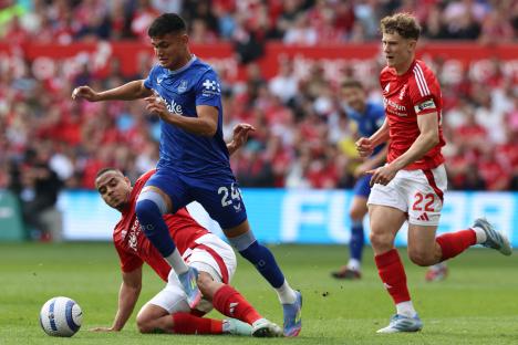 Everton's Alcaraz running past Nottingham Forest's Murillo during a soccer match.